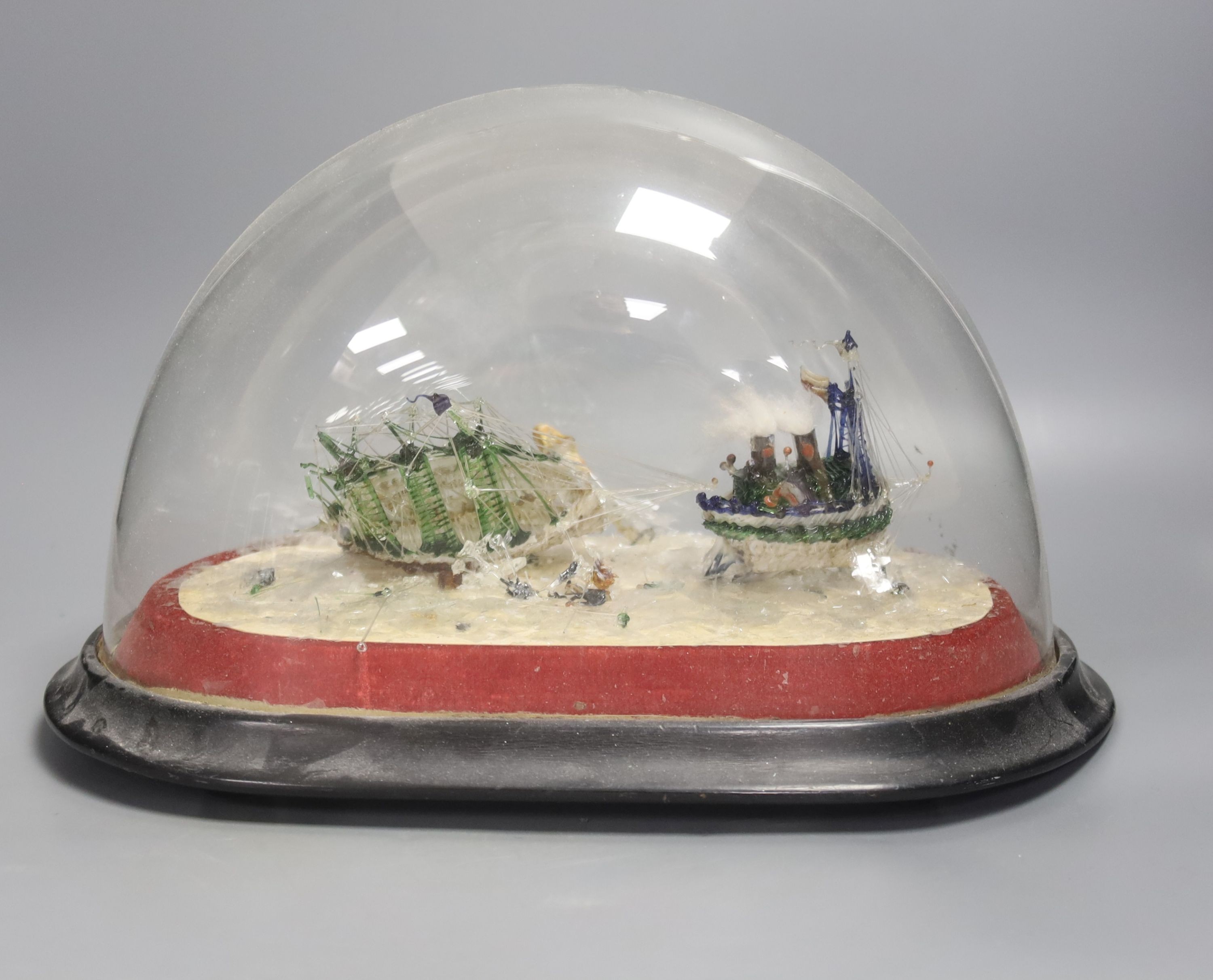 A Victorian spun glass diorama of ships, under a glass dome, height 22cm